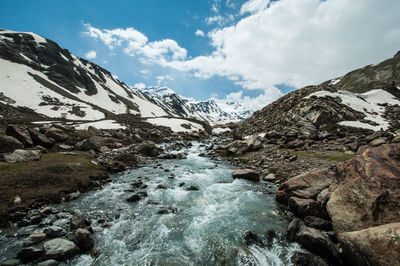 Scenic view of waterfall against sky during winter