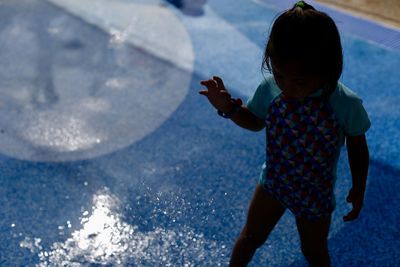 Full length of young woman standing in water