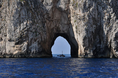 Scenic view of sea seen through cave