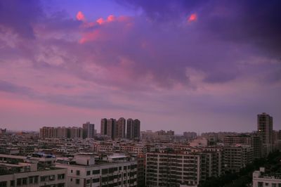 Cityscape against cloudy sky