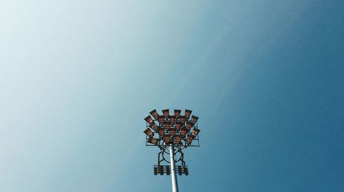 Low angle view of floodlight against clear blue sky