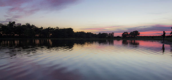 Scenic view of lake against sky during sunset