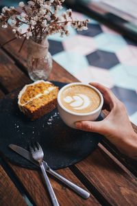 Cropped hand of person preparing food on table