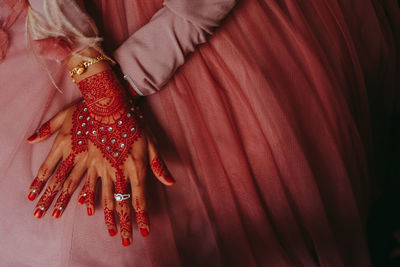 Midsection of woman showing henna tattoo