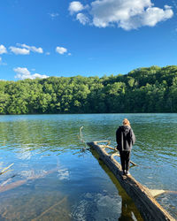 Woman in lake against sky