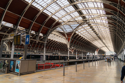 Inside large london train station glass and steel roof