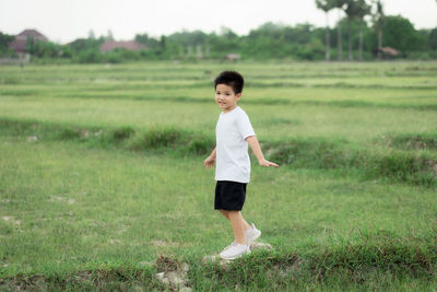 Full length of boy standing on field