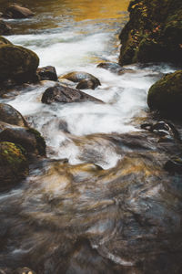 Stream flowing through rocks in sea