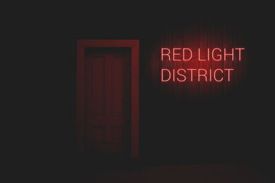 Illuminated text on red door