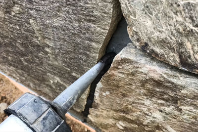 High angle view of wooden post on rock