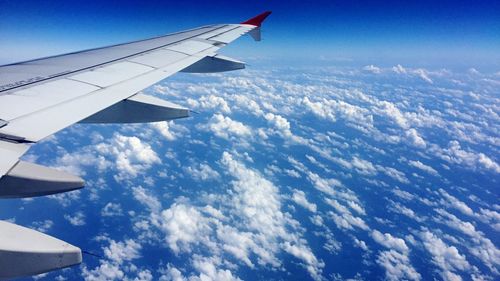 Cropped image of airplane wing over landscape