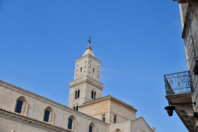 Low angle view of historic building against clear blue sky