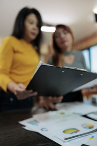 Businesswoman using laptop at table