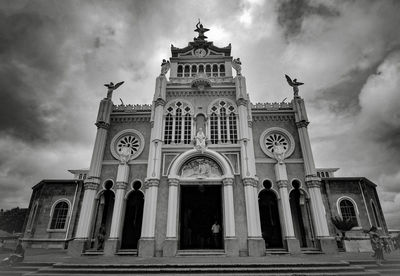 Low angle view of building against cloudy sky