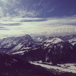 Scenic view of snowcapped mountains against sky