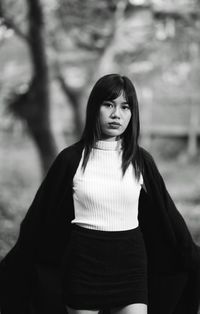 Portrait of young woman standing outdoors