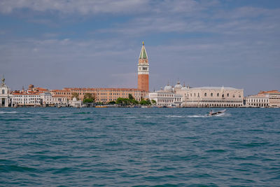 View of buildings against cloudy sky