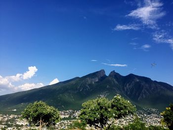 Scenic view of mountains against blue sky