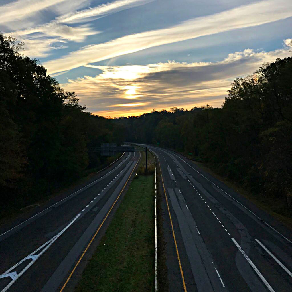 VIEW OF HIGHWAY AGAINST SKY DURING SUNSET