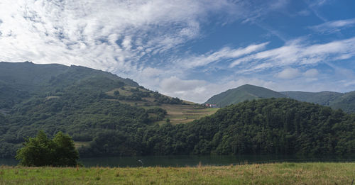 Scenic view of lake and mountains against sky