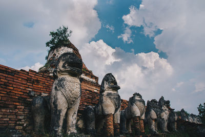 Low angle view of statue against cloudy sky