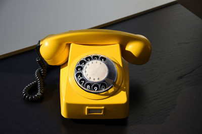 Close-up of telephone booth on table