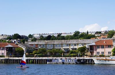 View of town by river against clear sky