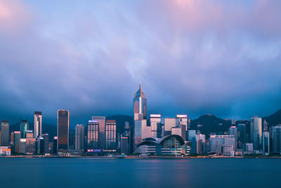 Illuminated buildings in city against sky