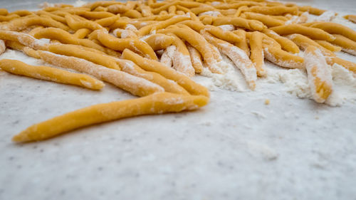 High angle view of dough with flour on table