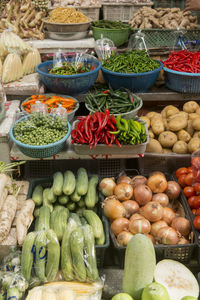 High angle view of various vegetables for sale arranged at market stall