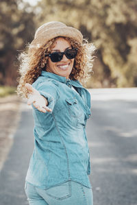 Young woman wearing sunglasses standing outdoors