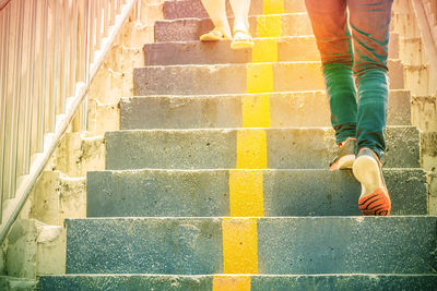 Low section of people walking on staircase