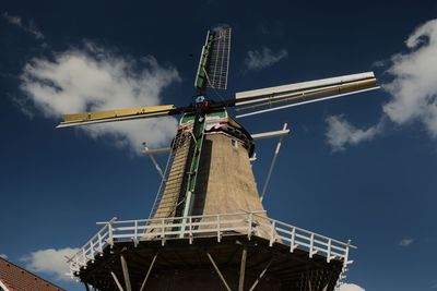 Low angle view of traditional windmill against sky