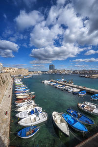 High angle view of harbor against cloudy sky