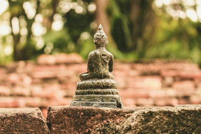 Close-up of buddha statue on wall