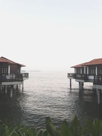 House by sea against clear sky