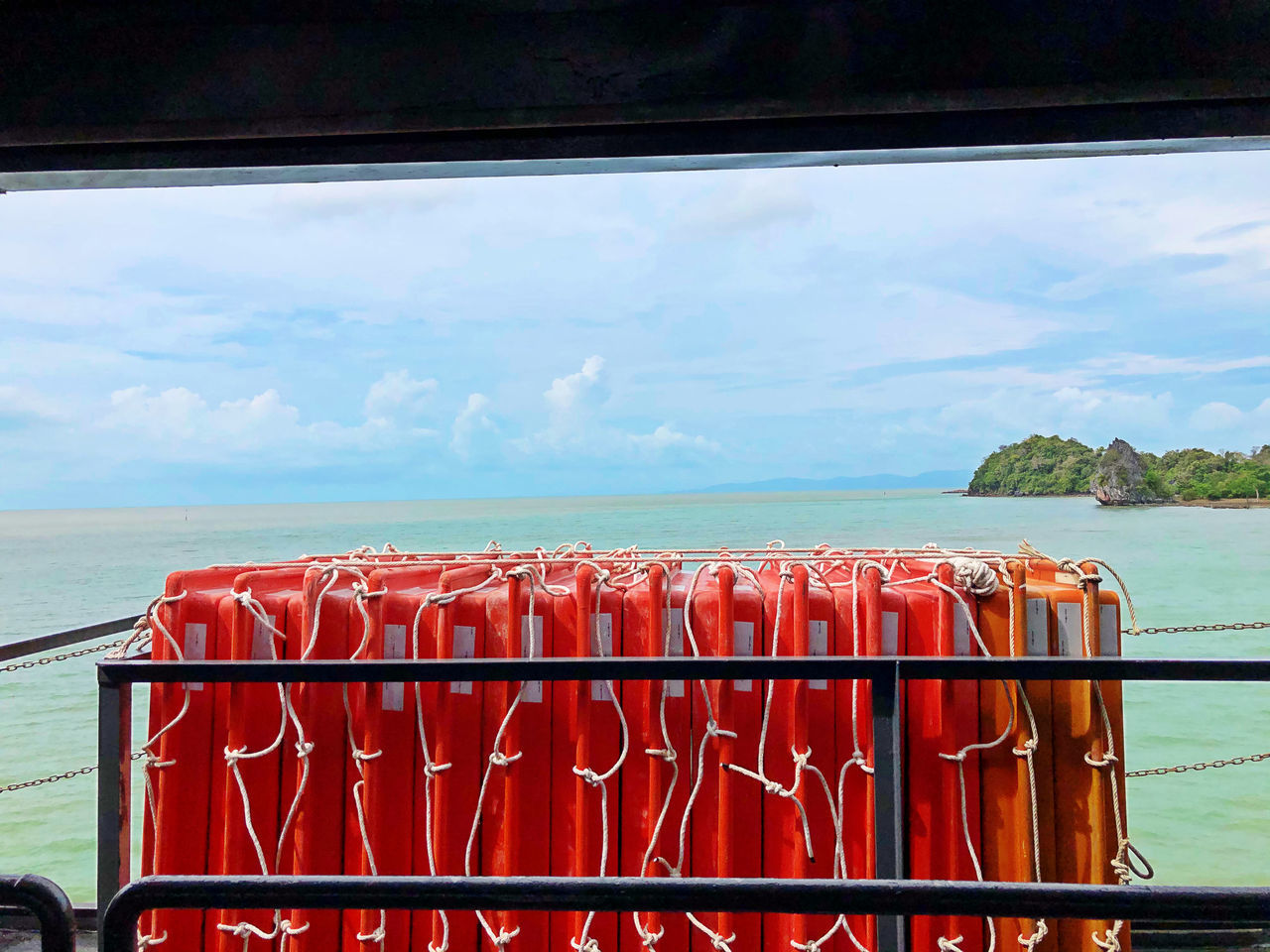 RED RAILING AGAINST SEA