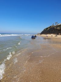 Scenic view of sea against clear blue sky