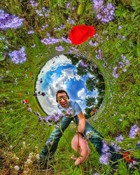 Portrait of smiling young man against white flowering plants