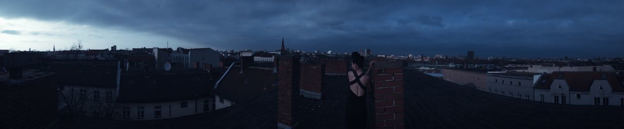 View of cityscape against cloudy sky