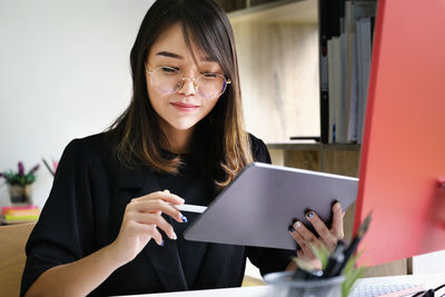 Portrait of young woman using smart phone