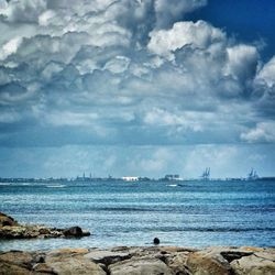 Scenic view of sea against cloudy sky