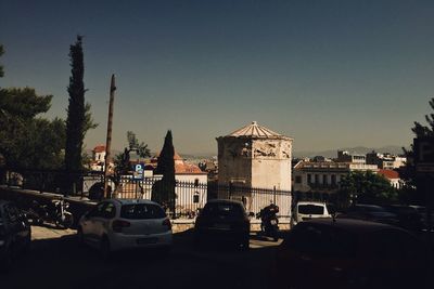 Cars on city against clear sky