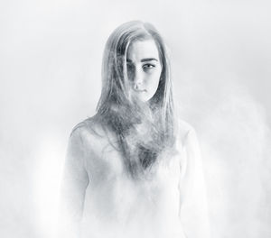 Portrait of young woman amidst smoke