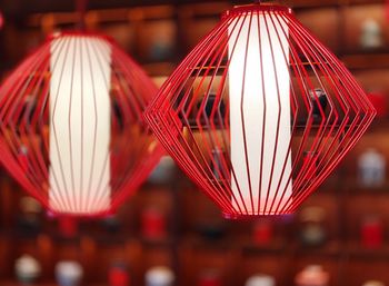 Close-up of illuminated lighting equipment hanging indoors