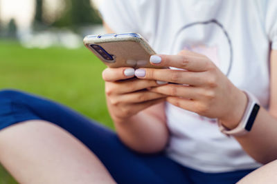 Midsection of man using mobile phone