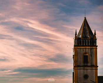 Low angle view of building against sky during sunset