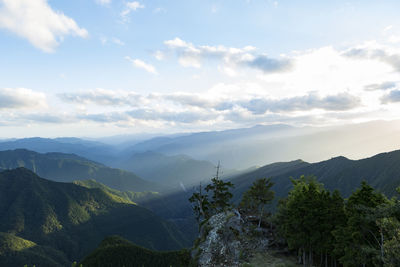 Panoramic shot of countryside landscape against mountain range