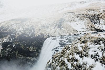 Scenic view of waterfall against sky