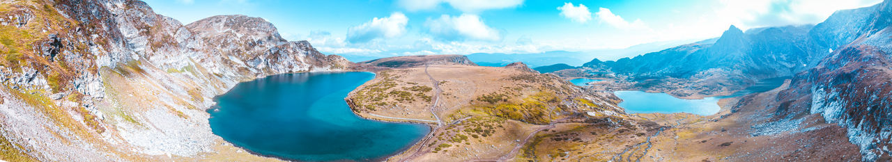 Panoramic view of land and mountains against sky